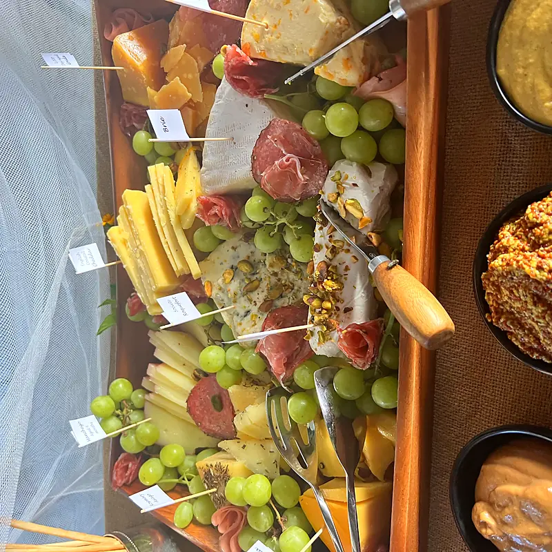 Grazing board of cured meats, cheeses, grapes and dips