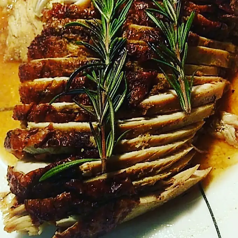 Sliced roast carved and finished with fresh rosemary