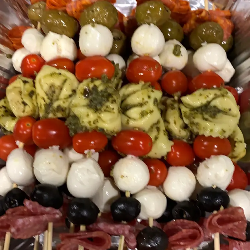 Tray of caprese skewers with tomato, mozzarella and basil